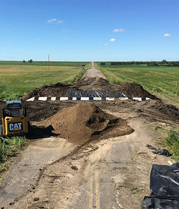 Lange Trenching installing an underground road culvert