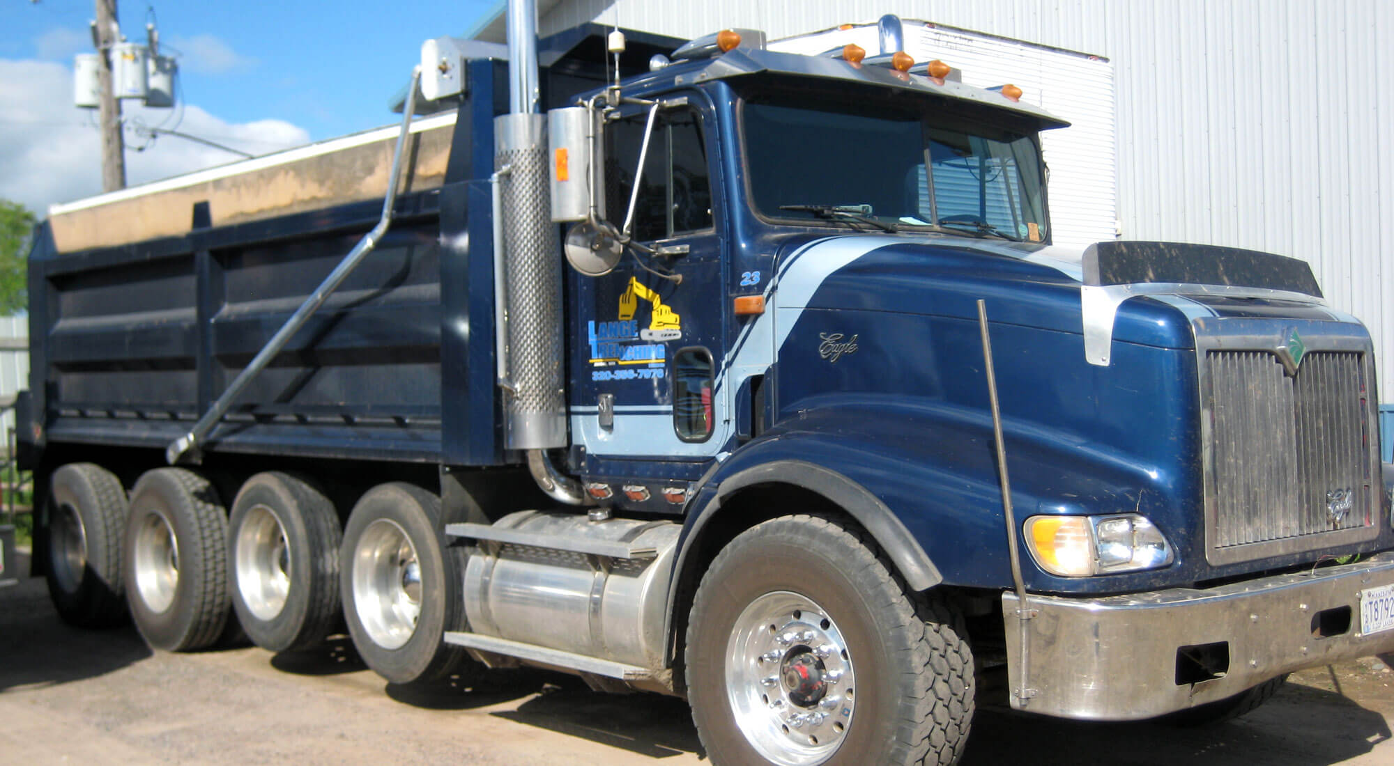 Dark blue Lange Trenching, Inc. dump truck